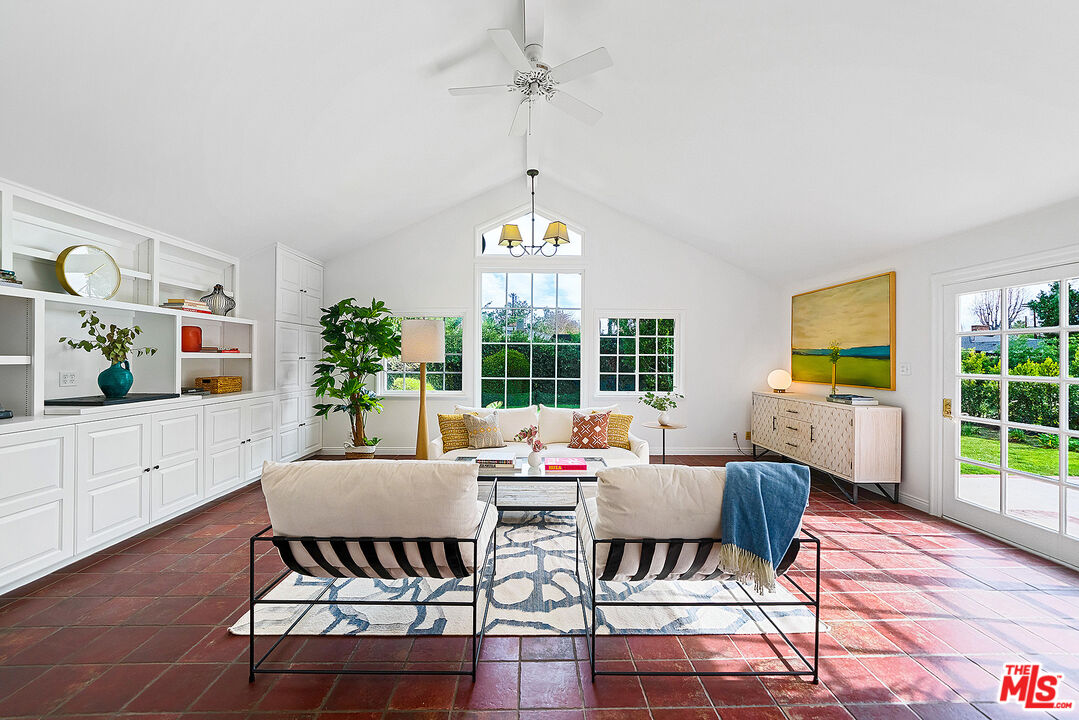 a living room with furniture a window and a table