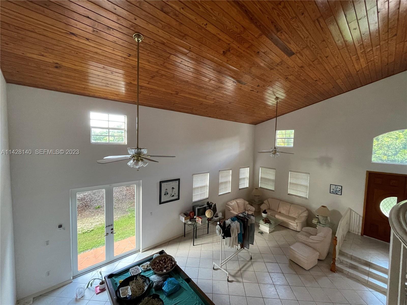 33300 Southwest 202nd Avenue Homestead, FL 33030 - Photo 11 of 42 a living room with furniture and a window
