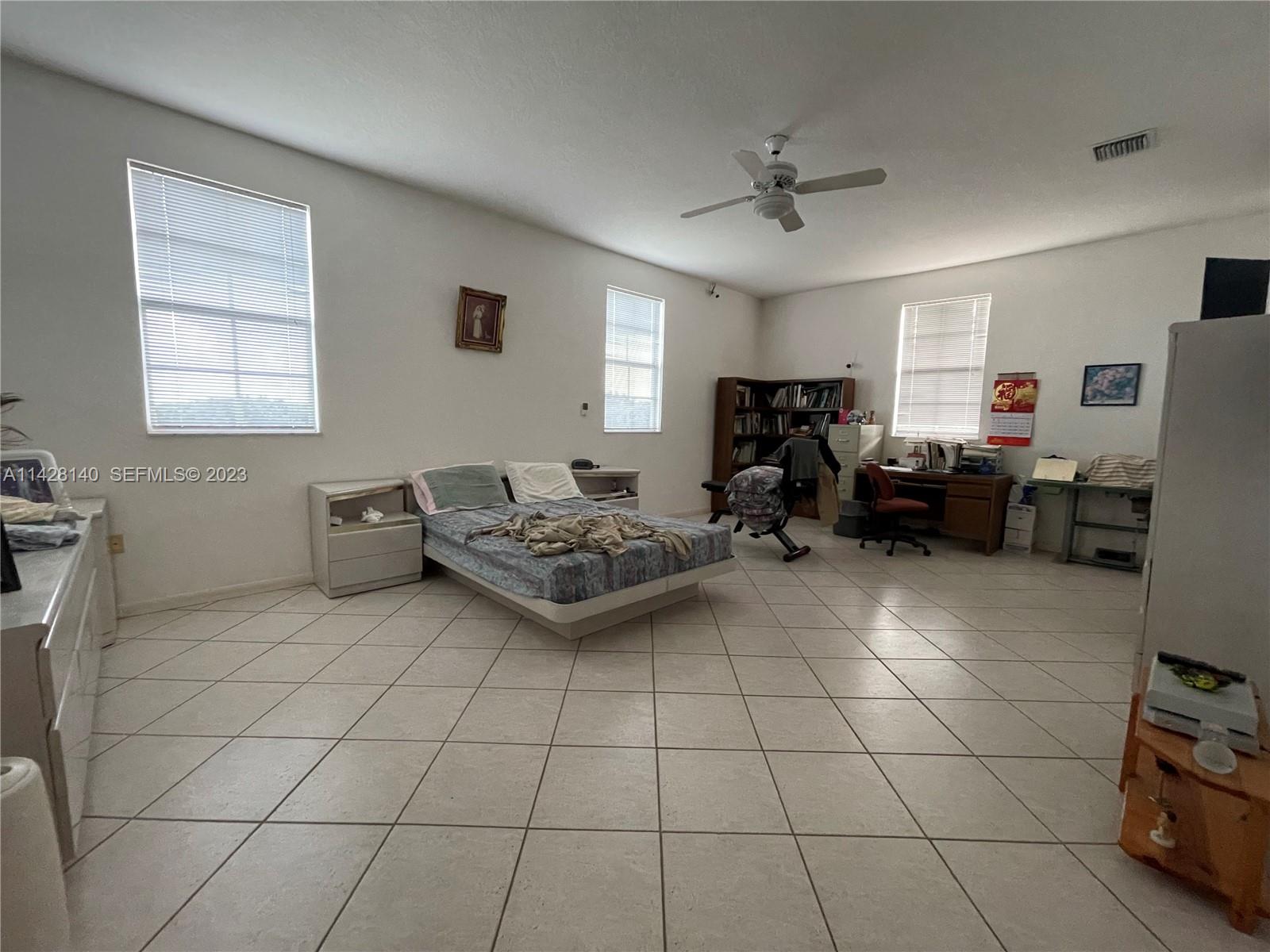 33300 Southwest 202nd Avenue Homestead, FL 33030 - Photo 12 of 42 a living room with furniture and a chandelier