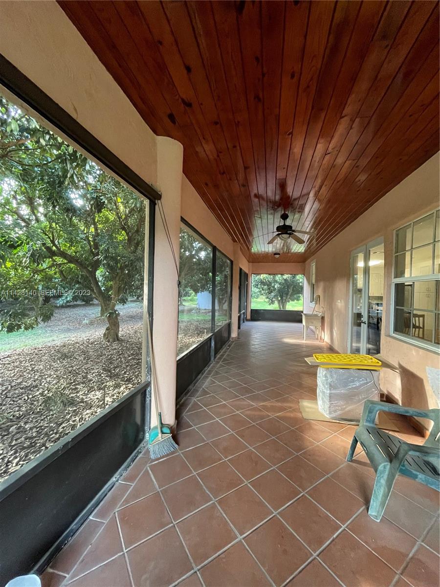 33300 Southwest 202nd Avenue Homestead, FL 33030 - Photo 17 of 42 a view of a porch with furniture and a yard