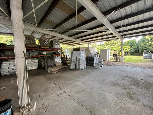 a backyard of a house with outdoor seating and trees