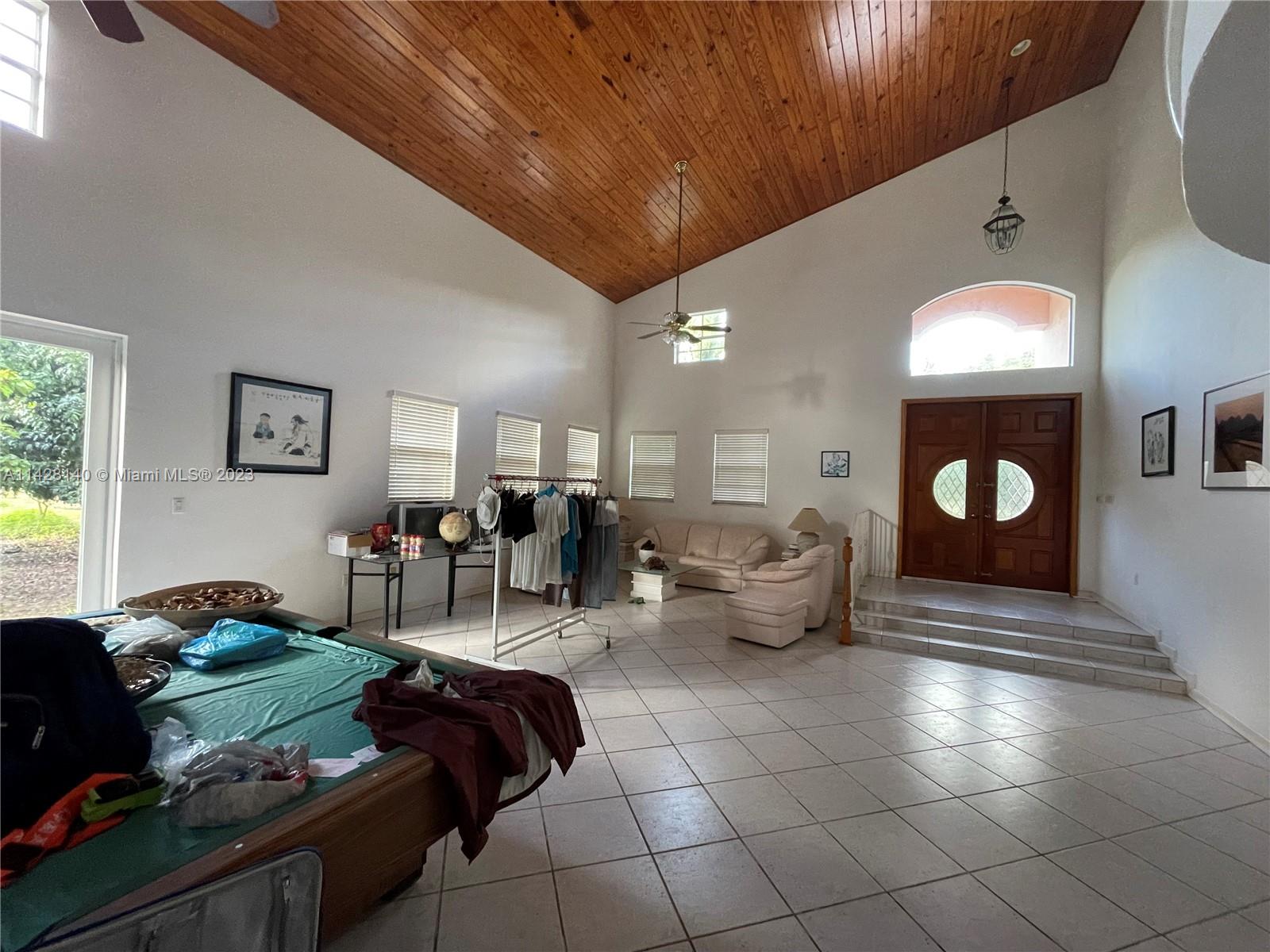 33300 Southwest 202nd Avenue Homestead, FL 33034 - Photo 5 of 42 a living room with furniture and a mirror