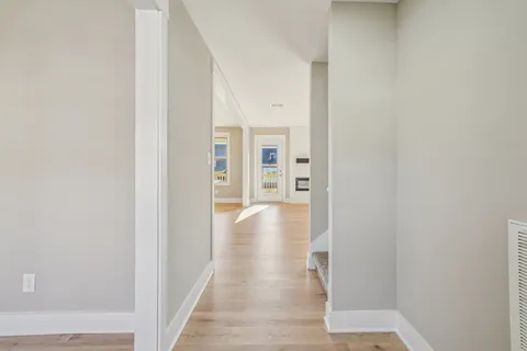 a bathroom with a bathtub shower sink vanity mirror and toilet