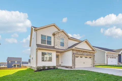 a view of a house with a backyard