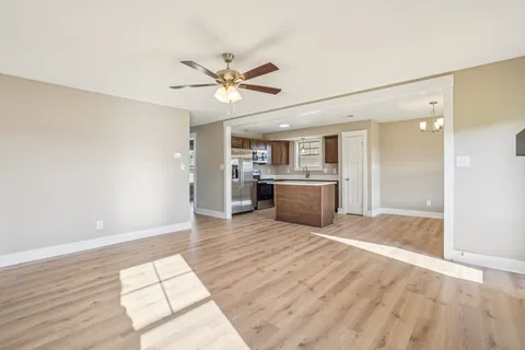 a large kitchen with stainless steel appliances granite countertop a sink and a stove