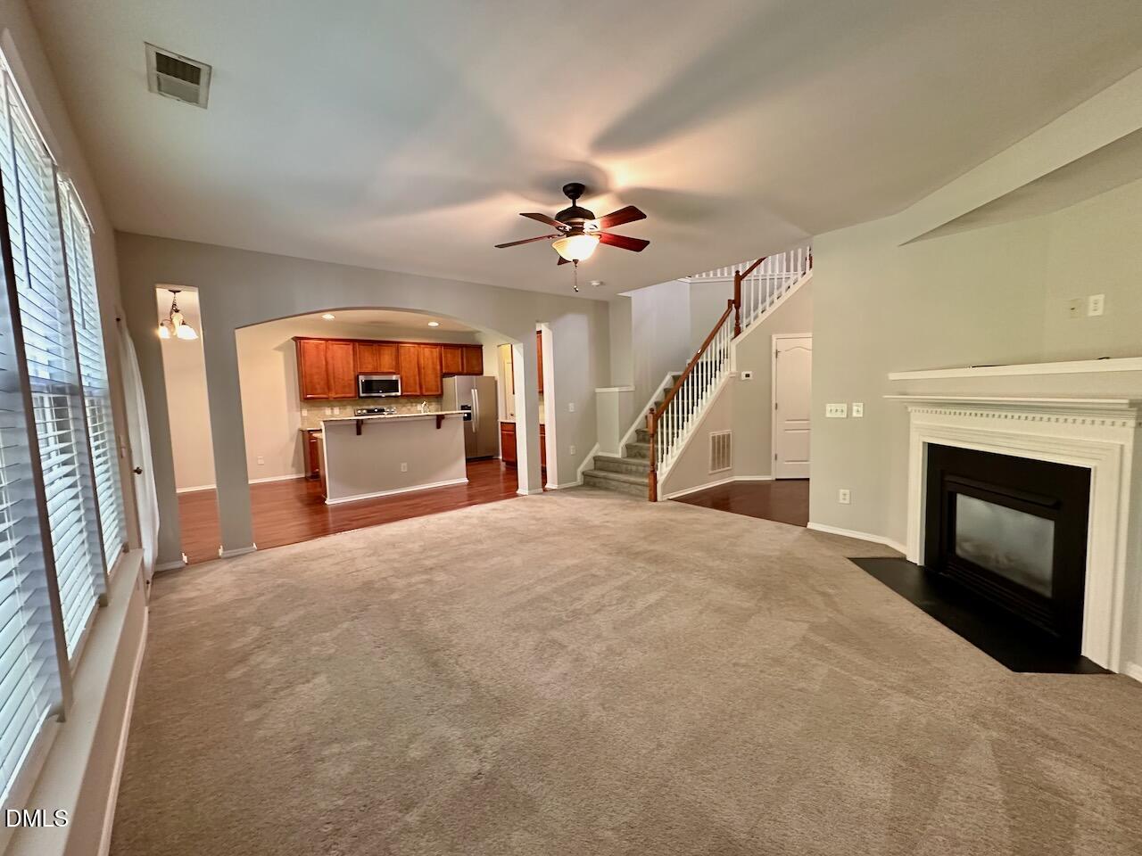 8208 Stone Cellar Drive Raleigh, NC 27613 - Photo 9 of 34 a open kitchen with fireplace and wooden floor