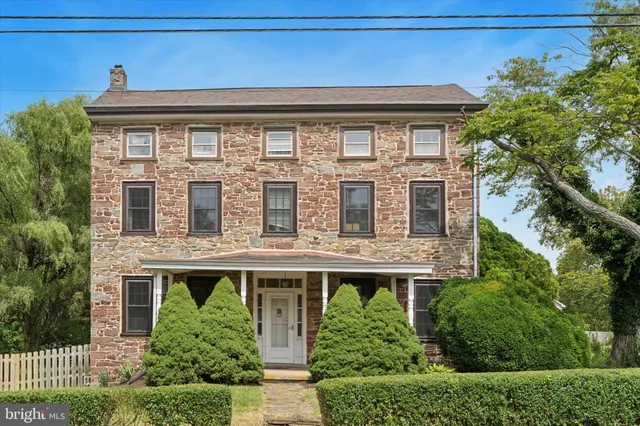 a front view of a house with plants