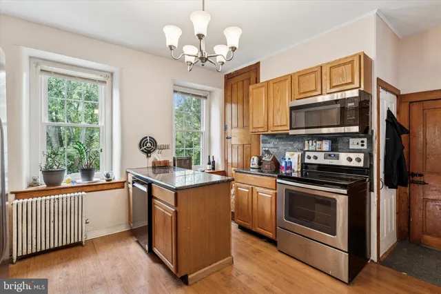 a kitchen with stainless steel appliances granite countertop a stove and a sink