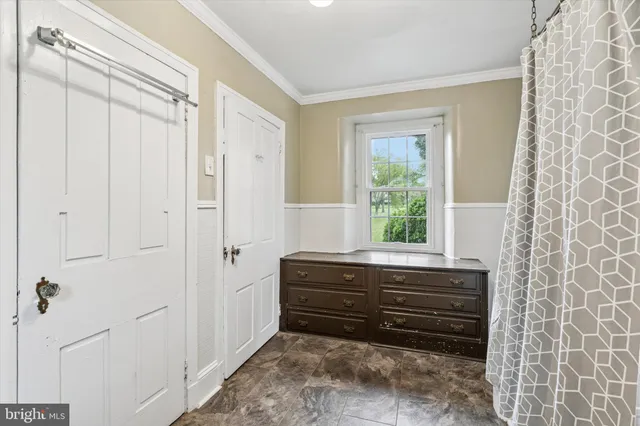 a room with a dresser and a window