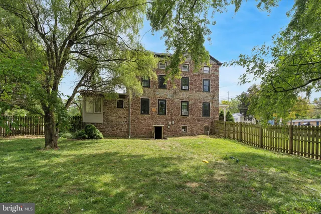 a view of a yard with large trees