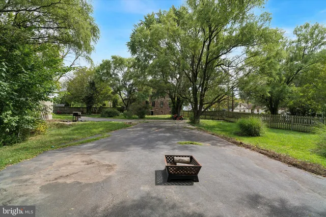 a view of a street with a house in the background