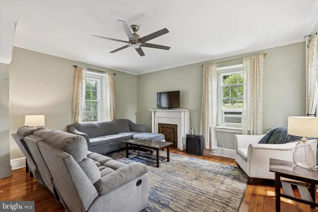 a living room with furniture a fireplace and a window