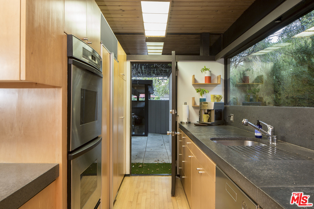 616 Cold Canyon Road Calabasas, CA 91302 - Photo 13 of 51 a kitchen with stainless steel appliances granite countertop a sink a stove and a refrigerator