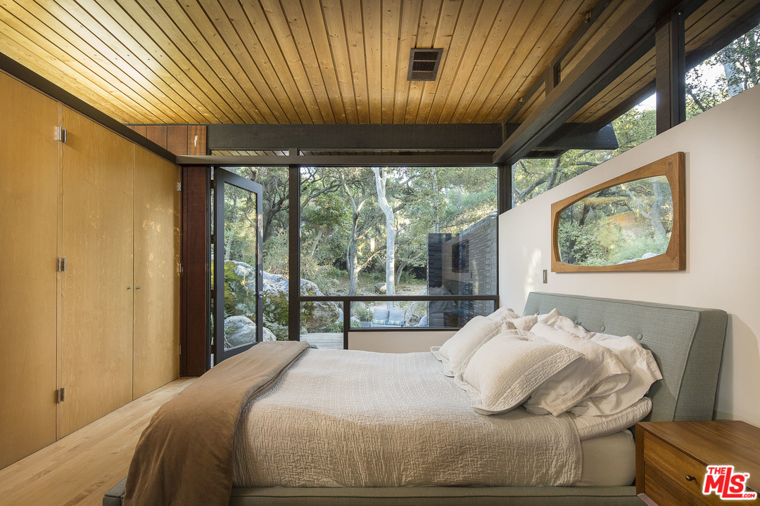 616 Cold Canyon Road Calabasas, CA 91302 - Photo 14 of 51 a bedroom with a bed and wooden floor