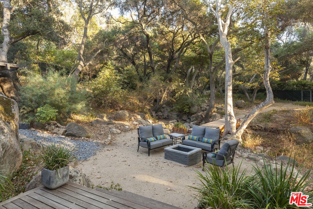 616 Cold Canyon Road Calabasas, CA 91302 - Photo 17 of 51 a view of a backyard with sitting area