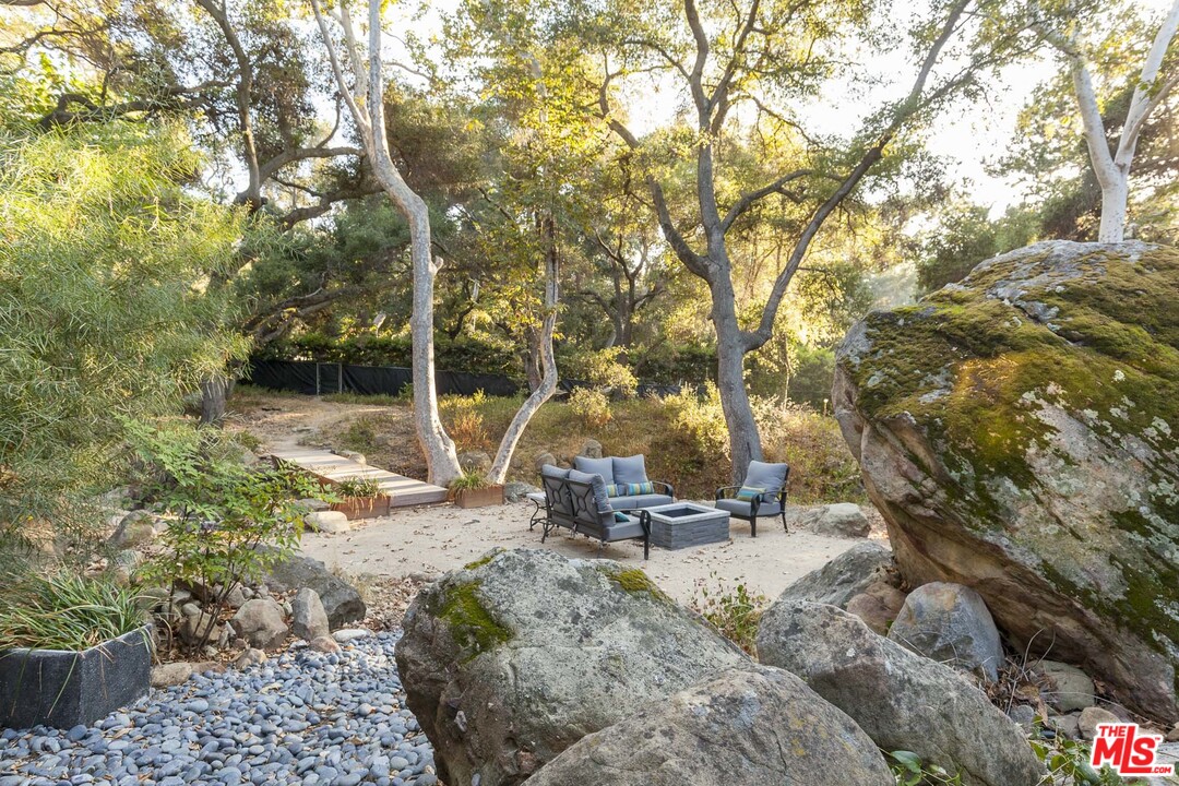 616 Cold Canyon Road Calabasas, CA 91302 - Photo 30 of 51 a backyard of a house with yard and outdoor seating