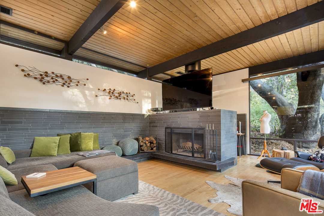 616 Cold Canyon Road Calabasas, CA 91302 - Photo 4 of 51 a living room with furniture and a fireplace