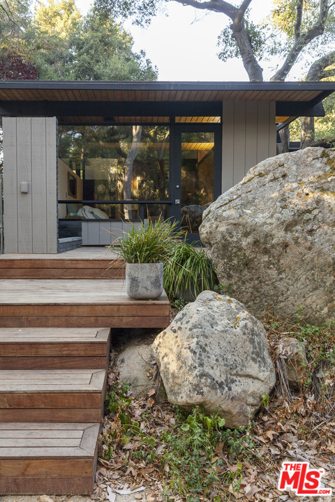 616 Cold Canyon Road Calabasas, CA 91302 - Photo 33 of 51 a front view of a house with garden
