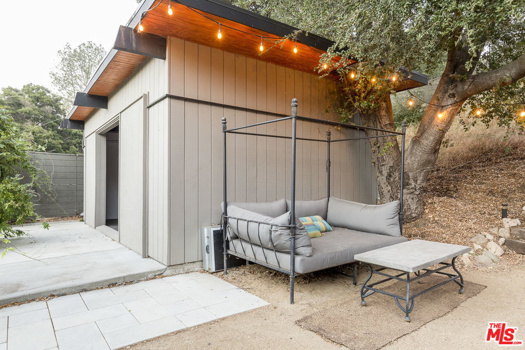 616 Cold Canyon Road Calabasas, CA 91302 - Photo 40 of 51 a backyard of a house with table and chairs