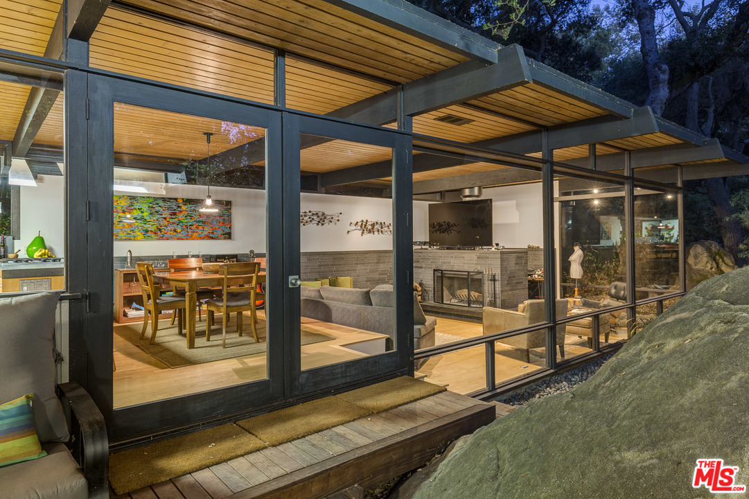 616 Cold Canyon Road Calabasas, CA 91302 - Photo 47 of 51 a view of porch with a table and chairs under an umbrella