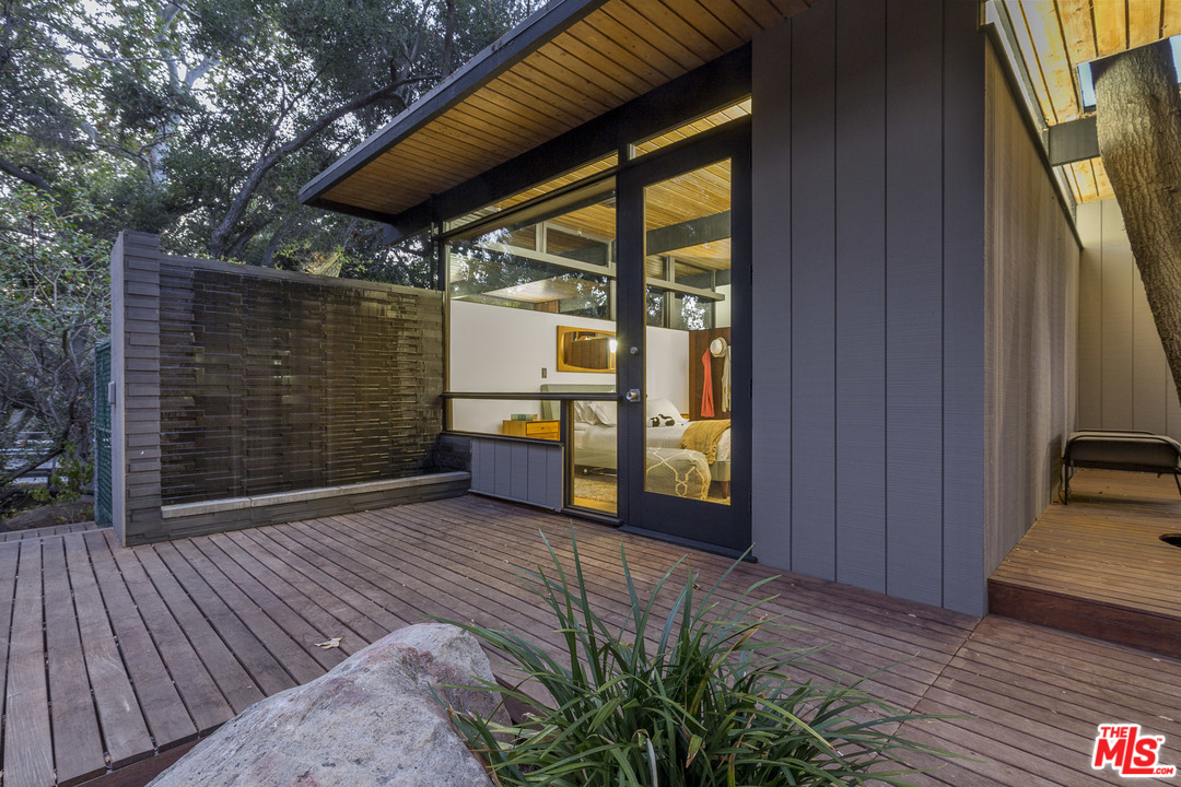 616 Cold Canyon Road Calabasas, CA 91302 - Photo 49 of 51 an empty room with wooden floor and windows