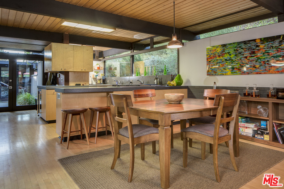 616 Cold Canyon Road Calabasas, CA 91302 - Photo 8 of 51 a dining room with a wooden table and chairs