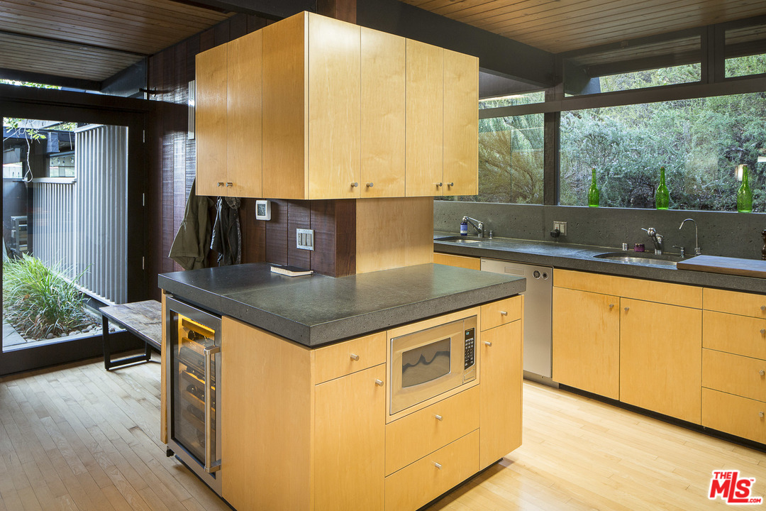 616 Cold Canyon Road Calabasas, CA 91302 - Photo 10 of 51 a kitchen with stainless steel appliances granite countertop a sink and a stove
