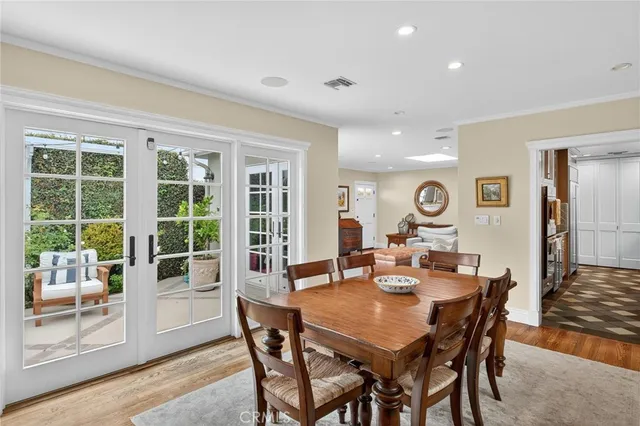 a view of a dining room and livingroom with furniture wooden floor and a rug