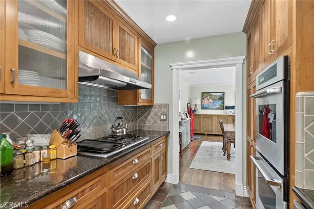 a kitchen with stainless steel appliances granite countertop a sink stove and cabinets