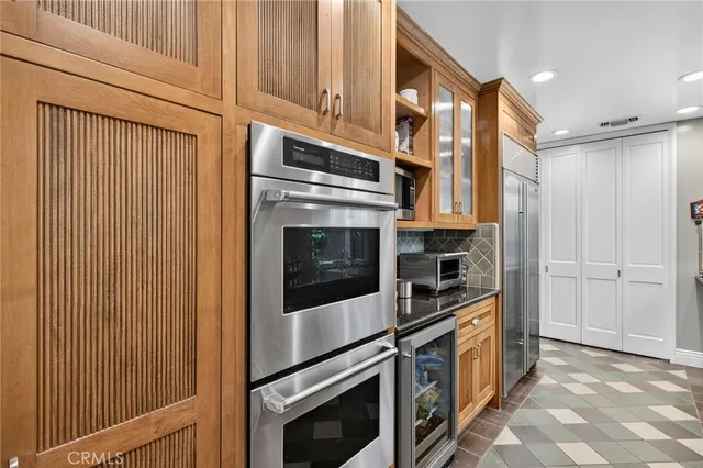 a kitchen with stainless steel appliances a refrigerator and cabinets