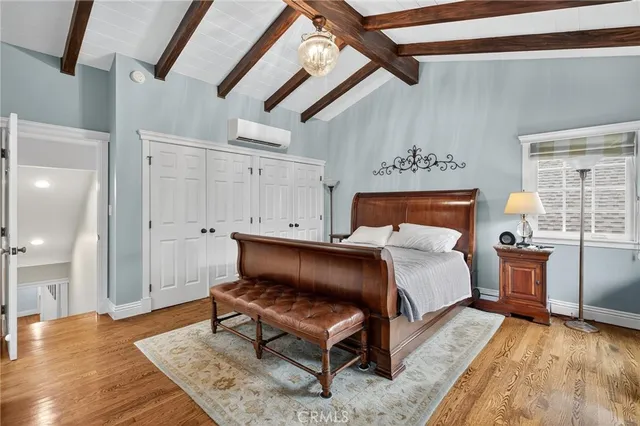 a bed room with a bed and a chair