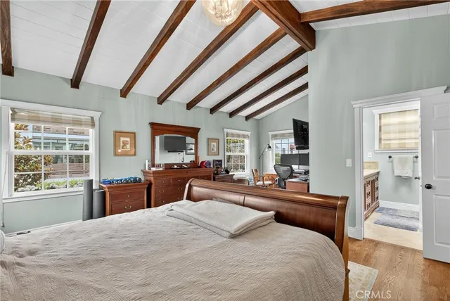 a bedroom with furniture and a large window