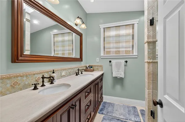 a bathroom with double vanity and a two mirror