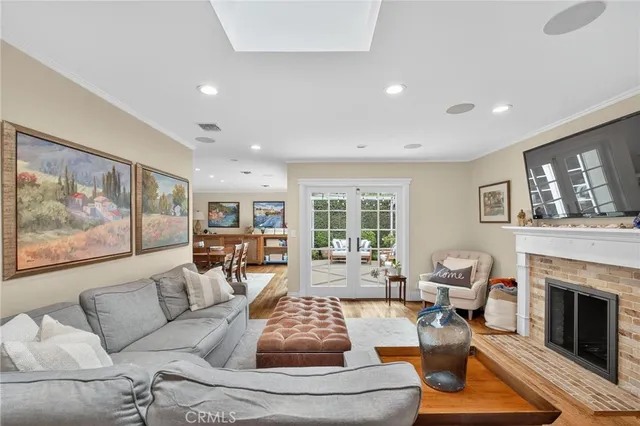 a living room with furniture a fireplace and a large window