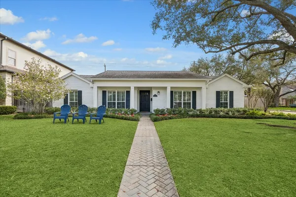 a front view of a house with garden and porch