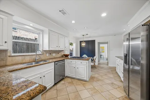 a kitchen with sink cabinets and dining table