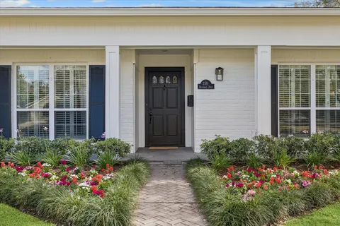 a house with a flower garden in front of it