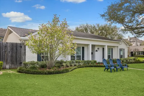 a view of a house with backyard porch and sitting area