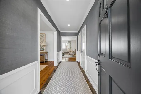 a view of a hallway with mirror and window