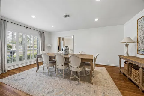 a dining room with furniture a rug and wooden floor