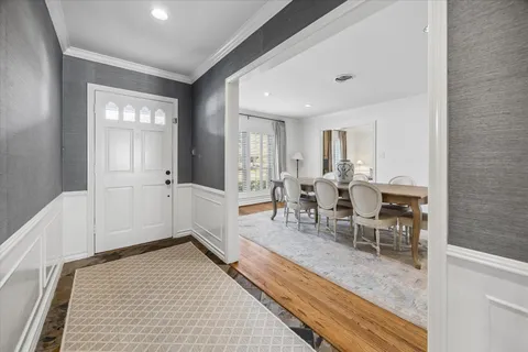 a dining room with furniture and a view of living room