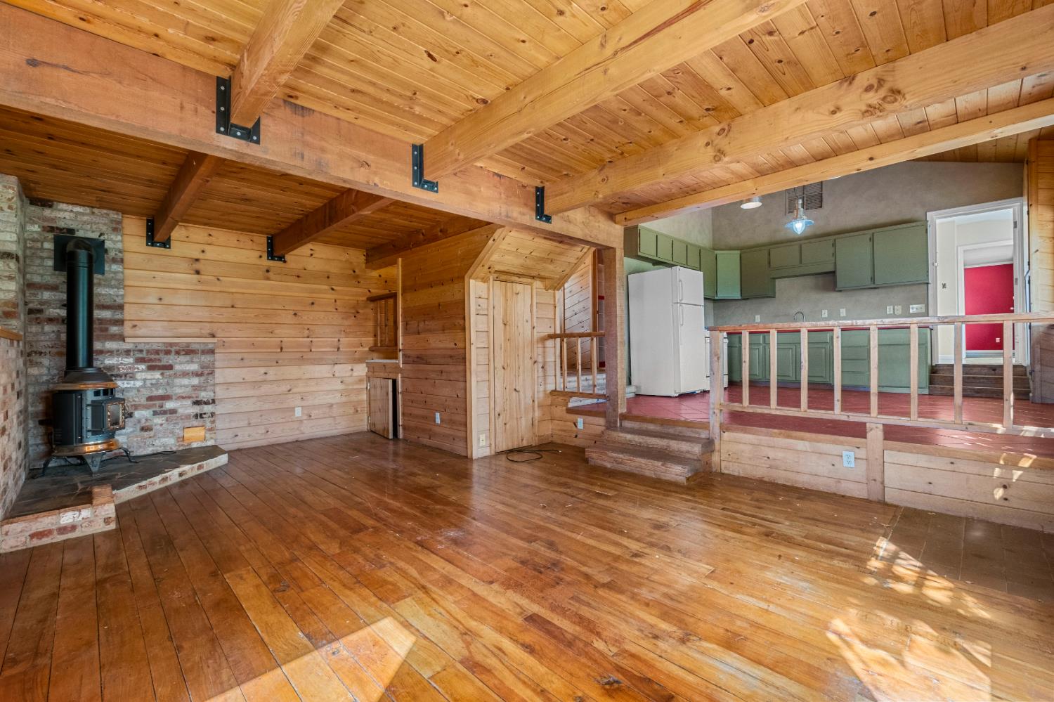 8221 Stoney Creek Road Somerset, CA 95684 - Photo 21 of 44 a view of an empty room with wooden floor