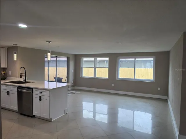 a large kitchen with stainless steel appliances a large window
