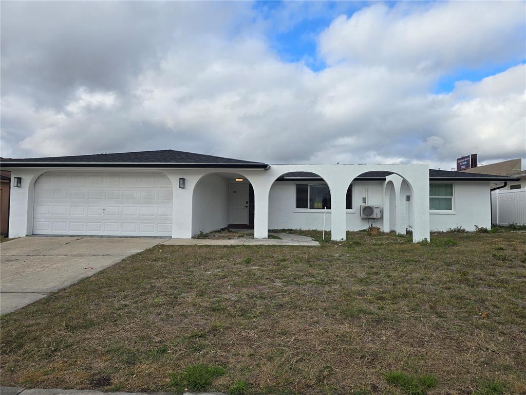 5813 Chapman Drive New Port Richey, FL 34652 - Photo 2 of 33 a front view of house with yard