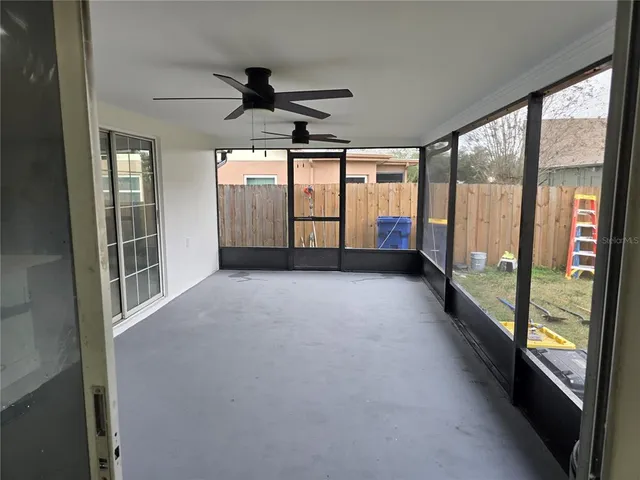 a view of a room with window and a ceiling fan