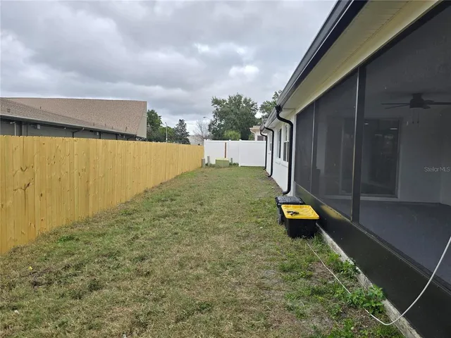 a view of a backyard with swimming pool