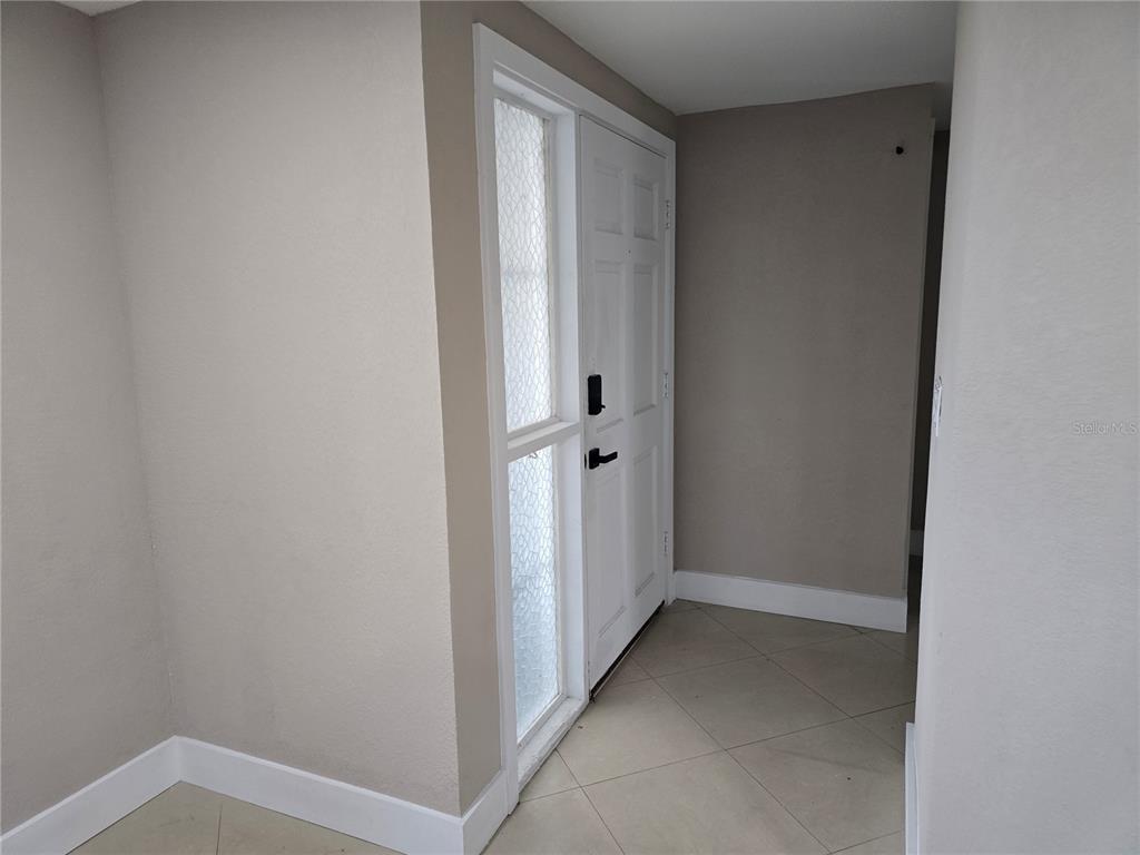 5813 Chapman Drive New Port Richey, FL 34652 - Photo 3 of 33 a view of room with hallway