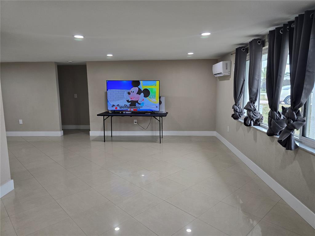 5813 Chapman Drive New Port Richey, FL 34652 - Photo 6 of 33 a view of a room with gym equipment and a large window