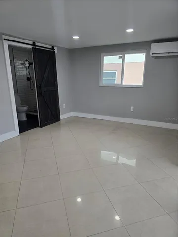 a view of an empty room and a window