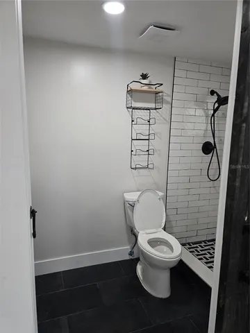 a white toilet sitting next to a bathroom